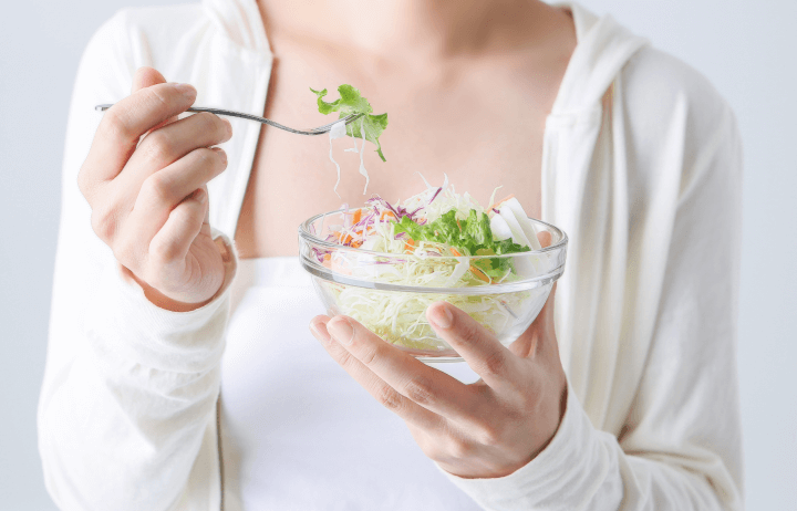 サラダを食べる女性